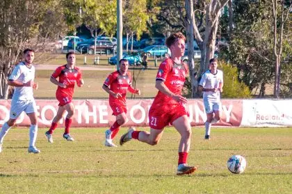 ON THE CHARGE: Redlands United’s man of the match Jack Skinner sets the Red Devils into attack. Photo: Ray Gardner