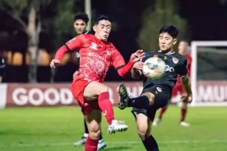 TUSSLE: Redlands’ Ryo Emoto wins the ball under pressure in the game against Eastern Suburbs FC.