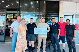 COMMUNITY SUPPORT: Andrew Field receives a cheque from Domino’s after a successful fundraising campaign.