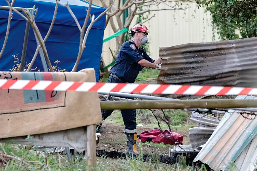 INVESTIGATION: Crews comb through the charred remains of a Russell Island home destroyed in the blaze. Photo: Russell Freeman/AAP Images