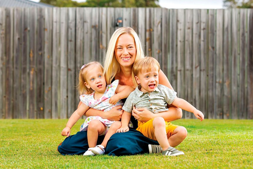 Mount Cotton mum Lauren Hoareau embraces her twins Amy and George. Photo: Josh Woning