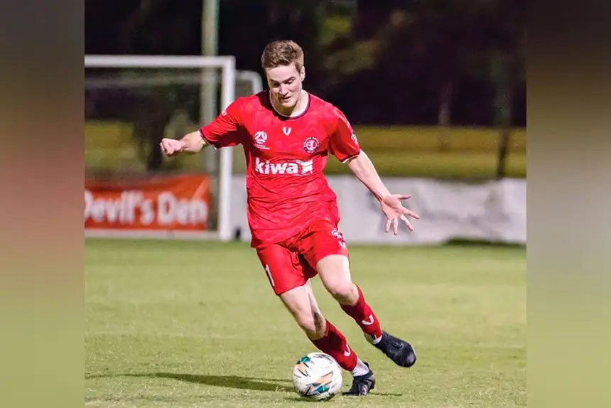 Redlands defender Benji Cameron brings the ball out of defence.