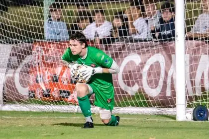 Redlands Goalkeeper Will Smith saves a Brisbane City attempt at goal and looks to send the Red Devils back into attack. Redlands Goalkeeper Will Smith saves a Brisbane City attempt at goal and looks to send the Red Devils back into attack.