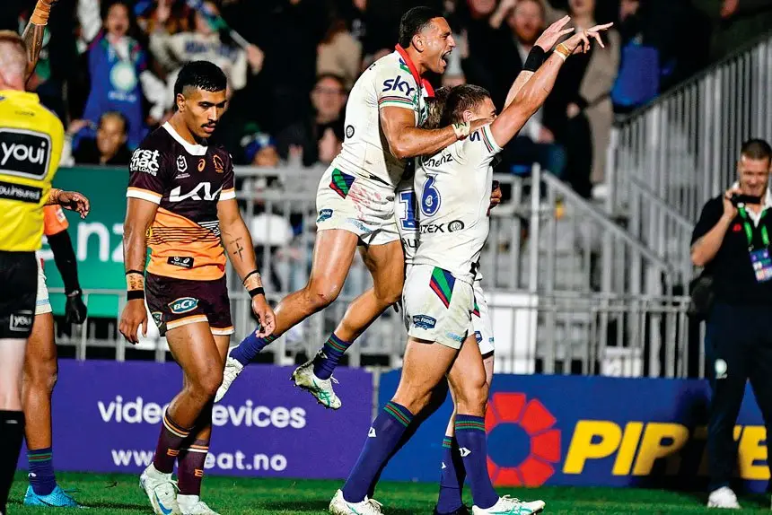 Warriors Freddy Lussick and Marcelo Montoya celebrate a try against the Broncos. PHOTO: AAP