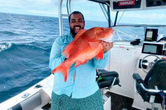 Recardo Caputa with a red emperor that almost pulled him off his boat.