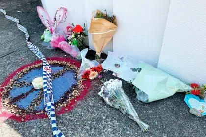 Flowers, cards and toys were left outside the Thorneside home where a girl and her babysitter died PHOTO: Savannah Meacham/AAP