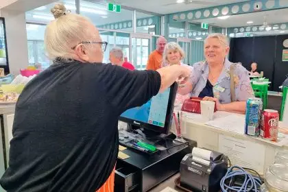 Christine Gross serves members at the Donald Simpson Centre cafe, a meeting place for isolated seniors.