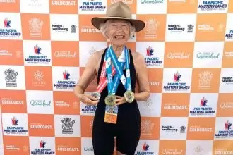 Jan Scott with her trio of medals from the Masters Games. She wore her late husband’s Akubra, for luck and support.