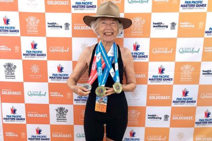 Jan Scott with her trio of medals from the Masters Games. She wore her late husband’s Akubra, for luck and support.