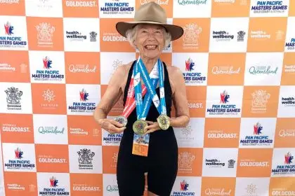Jan Scott with her trio of medals from the Masters Games. She wore her late husband’s Akubra, for luck and support.