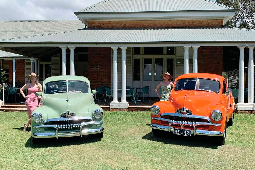 Twins Arabella and Lorielle Russell, of Alexandra Hills, who love the character of the FJ Holden ute. The green FJ utility is owned by local funeral celebrant Peter McCarthy.