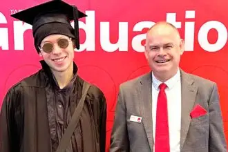 Director Craig Eades and Valedictorian William Moore.