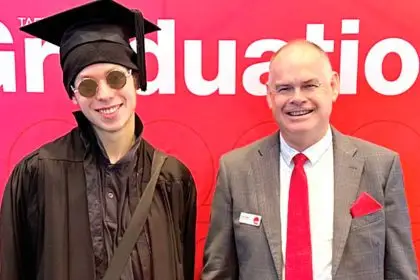 Director Craig Eades and Valedictorian William Moore.