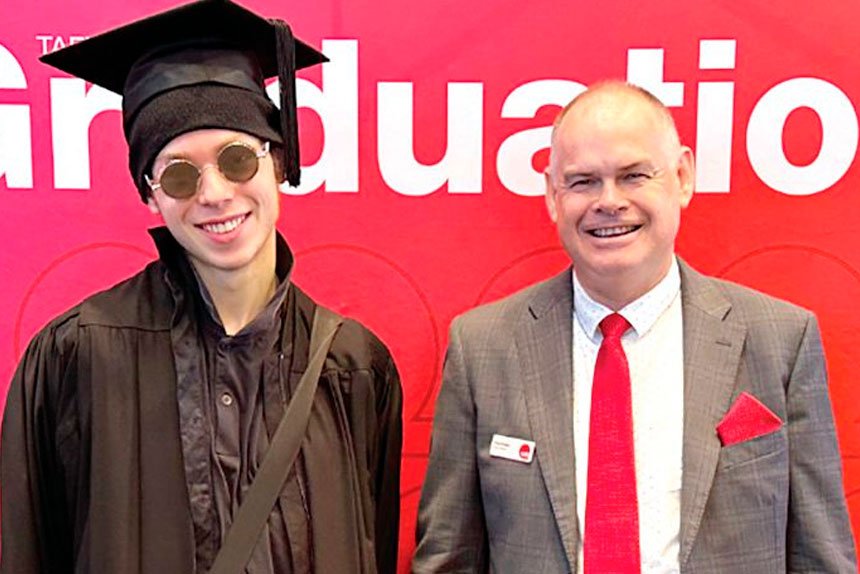 Director Craig Eades and Valedictorian William Moore.