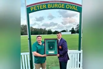 Home sweet home: Tigers president Sean Lloyd and Trent Conwell celebrate the arrival of Peter Burge’s baggy green cap.