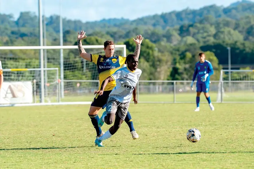 Wolves defender Dembele looks to mount an attack against Gold Coast United.