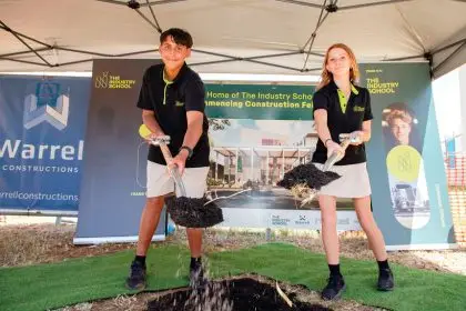 MAKING A START: The Industry School students participate in the traditional “turning the first sod” celebration.