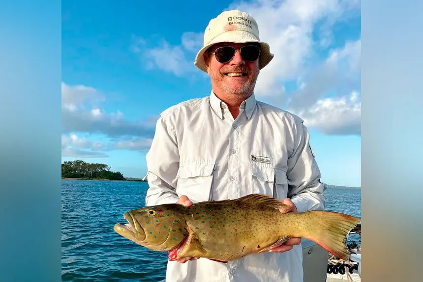 EASY DOES IT: Fair-weather fisherman Gary Chaplin with a 2.8kg coral trout.