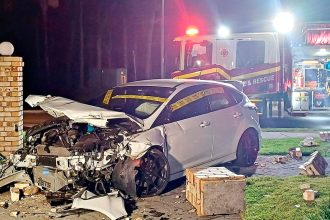 MAJOR DAMAGE: The wrecked car and fence after the crash.