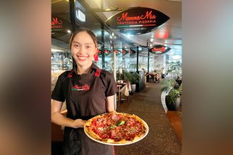 Waitress Cha Uly with an Al Capone pizza