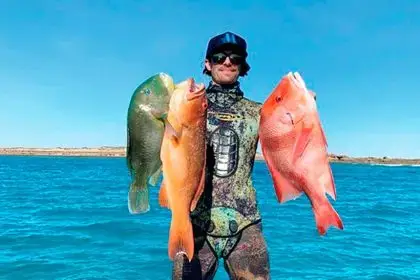 Fisherman Jimmy Atzeni with a black spot tusk fish, coral trout and red emperor.