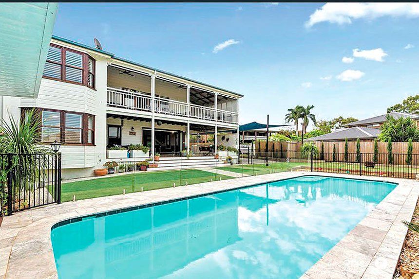 The glass-framed in-ground pool.