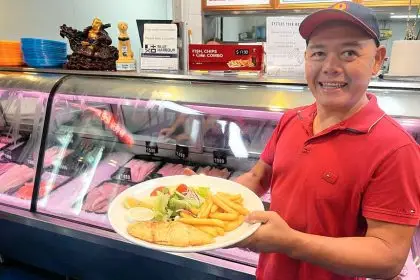 PERFECT PLATE: Owner Sam Tran with a classic fish and chips meal.