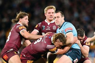 Blues captain Isaah Yeo is tackled by Reuben Cotter during last year’s State of Origin. PHOTO: AAP Image/Darren England)