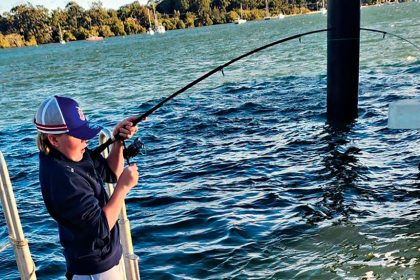 MAKING GRANDAD PROUD: Hugh Gordon reels in a large bream caught off the jetty of Lamb Island.