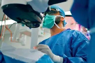 Ophthalmologist Dr Sunil Warrier, patient Malcolm Knight and the SeeLuma microscope being used in a procedure at Mater Private Hospital Redland.