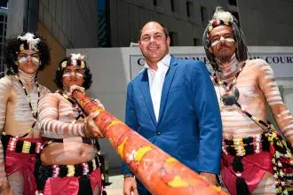 COURT VICTORY: Cameron Costello with Aboriginal dancers outside the Federal Court in Brisbane after formal recognition of the Quandamooka people as the traditional owners of Moreton Island.