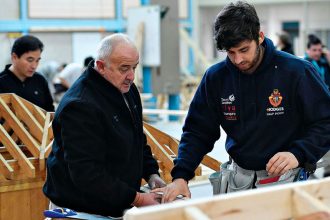 An experienced builder shares his experience with an apprentice carpenter.