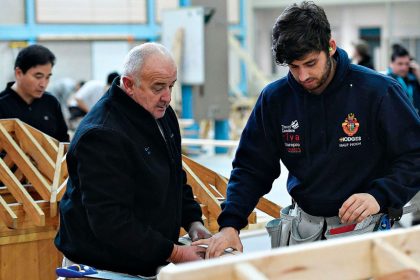 An experienced builder shares his experience with an apprentice carpenter.