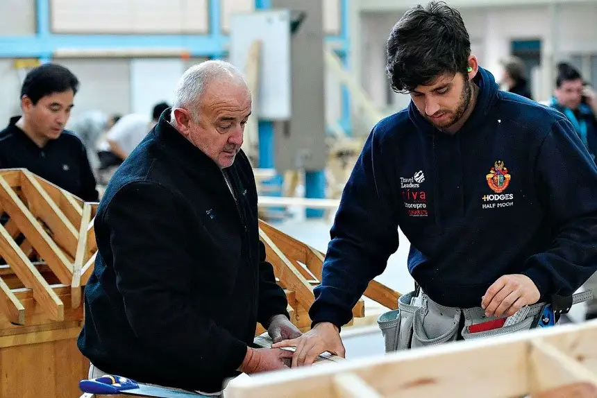 An experienced builder shares his experience with an apprentice carpenter.