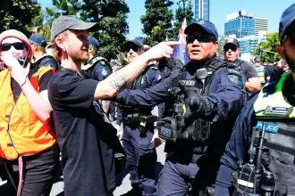 Police try to control the crowds during the March for Australia anti-immigration rally in Brisbane.