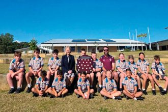 The Scenic Shores athletics team with State Member for Redlands Rebecca Young and HPE teacher Glen Robinson.