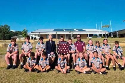 The Scenic Shores athletics team with State Member for Redlands Rebecca Young and HPE teacher Glen Robinson.