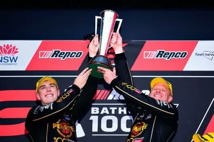Matt Payne and Garth Tander of Grove Racing lift the Peter Brock trophy after winning the Supercars Championship Bathurst 1000 at Mount Panorama Circuit in Bathurst. PHOTO: AAP Image/Dan Himbrechts