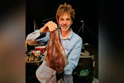 Luke Moloney with a squid caught on the Great Barrier Reef, off Gladstone.