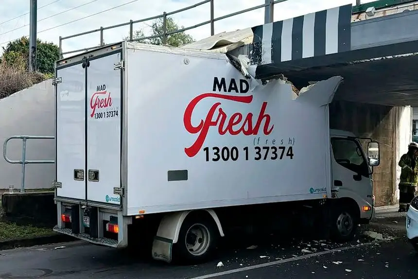 NOT AGAIN: A food delivery truck crashes into the Pine St Bridge protection beam.