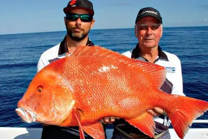 Greg Lamprecht and father Terry Lamprecht snag a 15kg red emperor off Fraser Island.