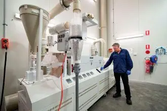 Senior site technician Des Broom operating a furnace used in the production of HPA at Lava Blue’s Alexandra Hills pilot plant.