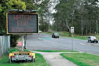 TAKE CARE: A sign warning motorists to be vigilant while driving through bushland containing a koala habitat.