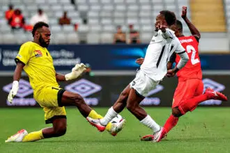 PNG Hekari FC goalkeeper Dave Tomare races out to shut down an attack from Solomon Kings FC’s Rafa Le’ai at, Eden Park, Auckland, on Sunday. Photo: Shane Wenzlick / www.phototek.nz