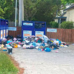 DUMPING GROUND: Bags of clothing and household items dumped around full Lifeline bins at Victoria Point.