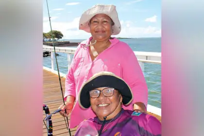 Cousins Madeline Solien-Suruman and Emily Tongla chat and fish as a means of keeping in touch at least once a week.