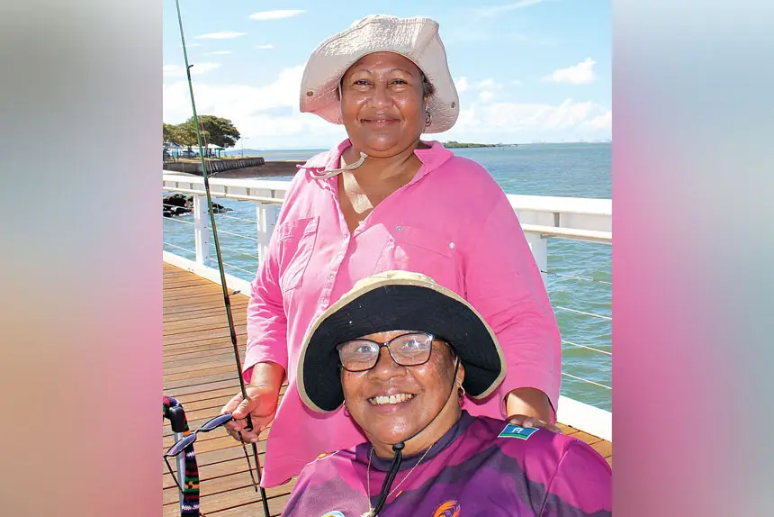 Cousins Madeline Solien-Suruman and Emily Tongla chat and fish as a means of keeping in touch at least once a week.