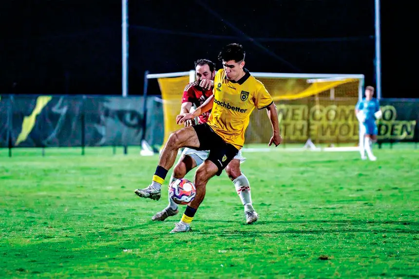 Wolves striker Fernando Nash shields the ball against Gold Coast Knights.