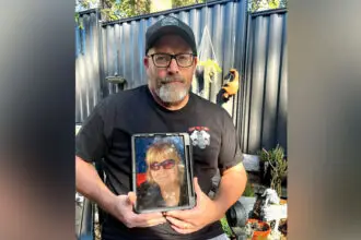 DISTRESSING: Shaun Hodges with a picture of his wife Judi.