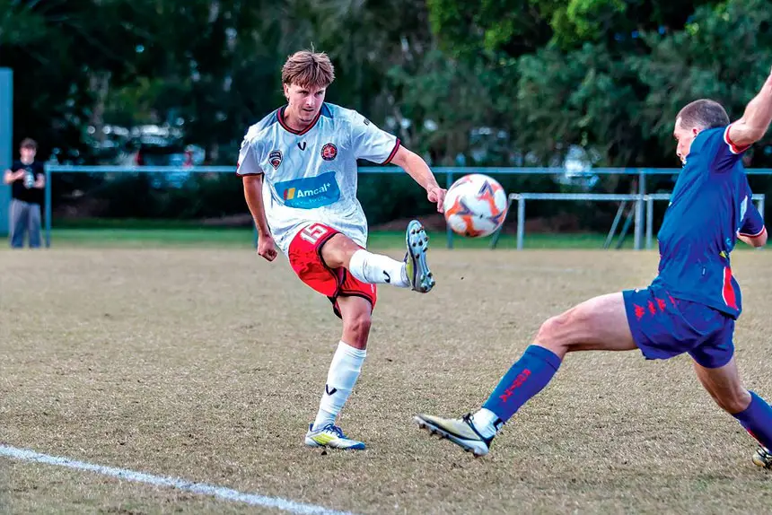 Redlands United goalscorer Bailey Paxton sends the ball forward in his side’s dramatic 1-1 draw with Robina City. PHOTO: Ray Gardner